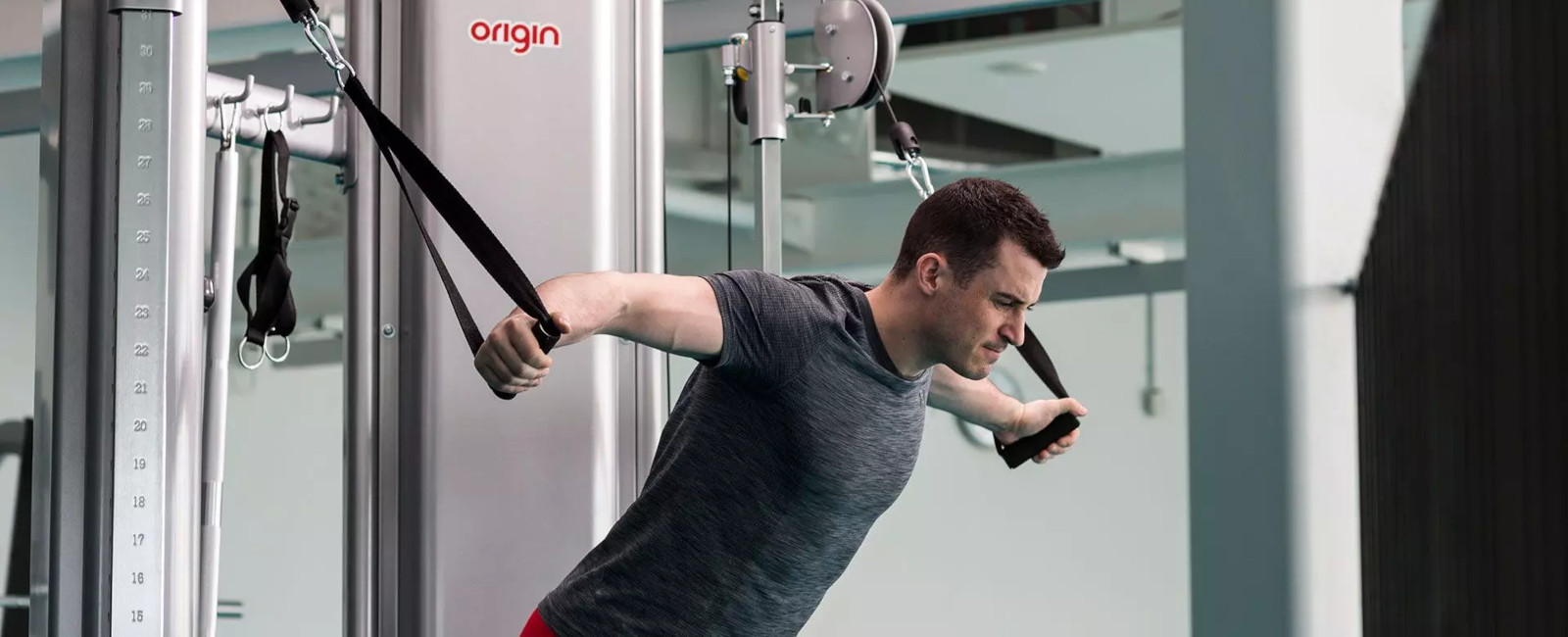 a man using an origin fitness strength machine
