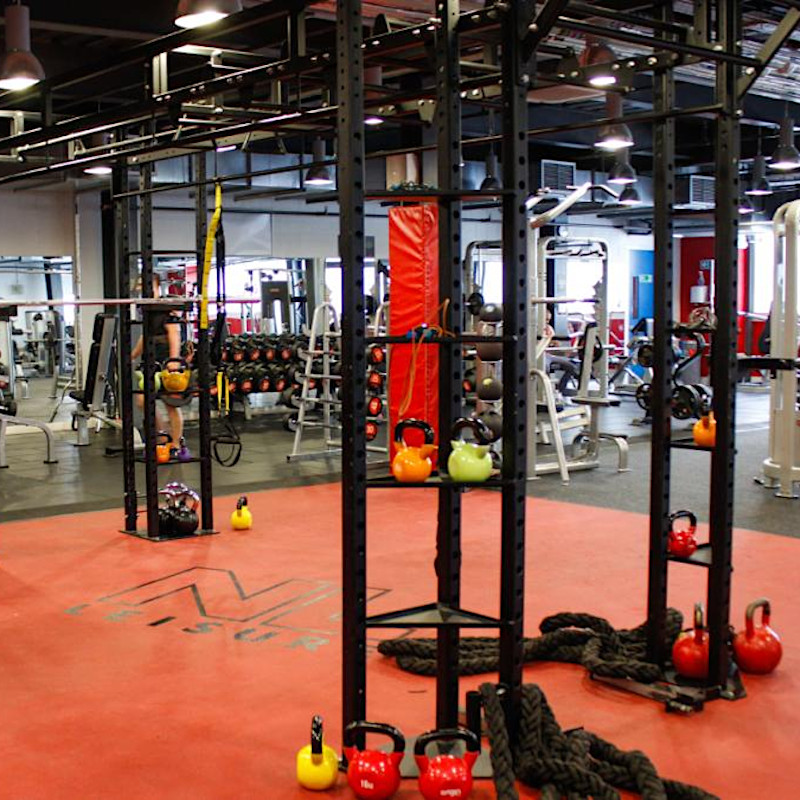 functional traininga rea in gym with red mat, bars, kettlebells