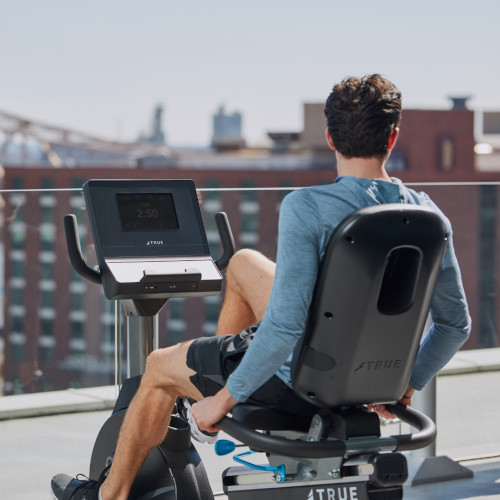 a man sitting on an exercise bike outside